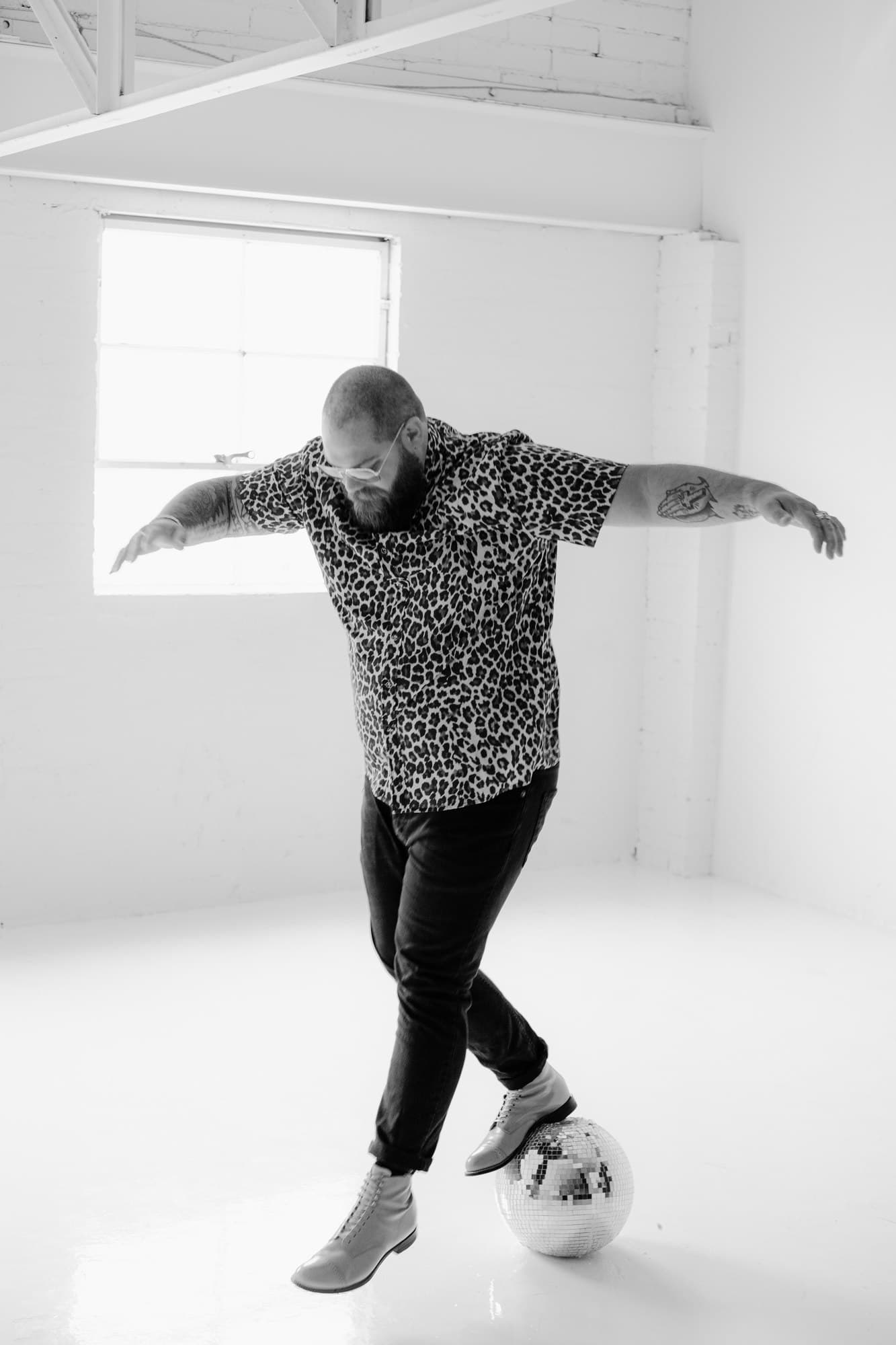 Taylor Anderson balancing on a disco ball
